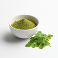 Organic Moringa Powder in a white ceramic bowl with fresh moringa leaves
